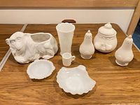 All eight white milk glass and ceramic items displayed together on table