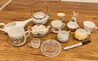 All thirteen miniature porcelain and glass pieces arranged for scale reference