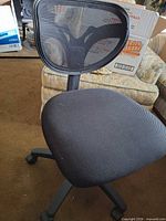 Front view of black mesh-back office chair with padded seat