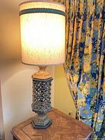 Complete lit lamp showing shade, body, and base