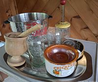 Group view of colander, platter, mortar & pestle, Coca-Cola glasses, carnival glass dish, chicken soup mug, coaster set and nut chopper