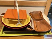 Stack of trays showing orange, yellow caddy, red tray, black rooster tray and green tray
