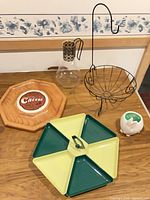 Group shot of all five items: cheese board, snack tray, carafe, fruit bowl stand, ceramic bunny
