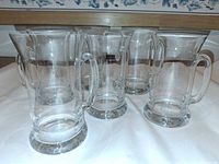 Front view of all six clear glass beer mugs