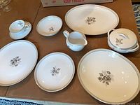 Overview showing oval platters, serving bowls, sugar bowl, creamer, cup and saucer sample