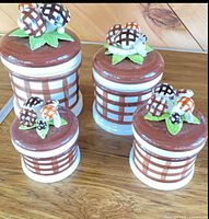 four graduated ceramic mushroom canisters with lids