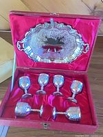 Box open showing tray and six cordial cups in red satin