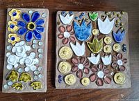 Front view of both earthenware plaques showing floral designs and glaze colors