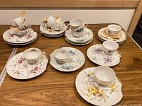 Assorted snack plates and teacups grouped on tabletop