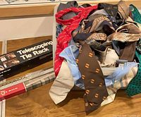 Plastic bin filled with numerous vintage neckties and two boxed tie racks