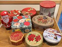 Group shot of all nine decorative tins on table