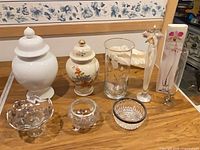 Group shot of both urns, large vase, bud vases and three silver-rimmed glass dishes