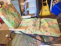Side view of chaise showing frame, wheels and cushions