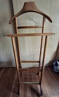 Front view showing full valet stand structure, hanger, trouser bar, and lower rail