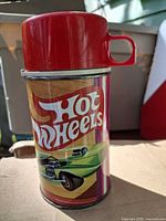 Front view showing Hot Wheels graphic and red cup lid attached