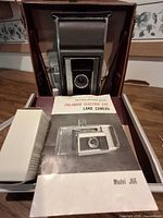 Camera in case with manual and accessory box visible