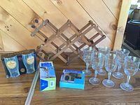 Overall lot with wooden wine rack, boxed accessories, beer glasses carrier and wine glasses