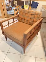 front view of wood armchair with cushions