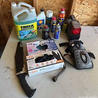 Overall view of lot showing fluids, WD-40 cans, gloves, tools, knee pads and tail light