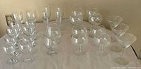 Full set of mixed clear stemware on table