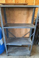 Front view of gray metal frame shelving unit with four wood shelves
