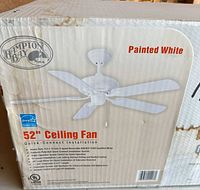 Front of factory box showing Hampton Bay branding, size and painted white fan image