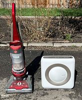 Hoover upright vacuum beside Coway air purifier