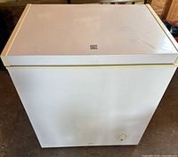 Front and top view of closed white chest freezer