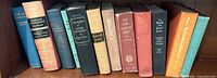 Spine view of all 10 clothbound books on shelf