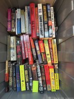 Overhead view of entire tote containing roughly forty paperbacks stacked in rows