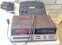 All three clock radios grouped together showing fronts, tops, controls, and cords