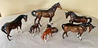 All seven porcelain horse figurines grouped together