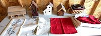 Full lot view on table showing birdhouses, linens, red napkins, wicker basket