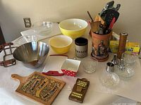 overview of entire lot on table showing bowls, knife block, utensil crock, pepper mill, cling wrap boxes, serving bowls