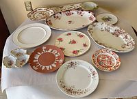 Group shot showing all twelve assorted plates, platters and bowls