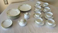Complete set laid out showing cups, saucers, plates, creamer, sugar bowl