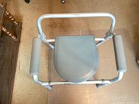 Top view showing padded armrests and closed seat lid