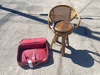 Suitcase open next to rattan swivel stool showing overall items included