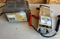 Both charger and tester side by side with leads visible