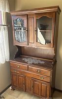 Full view of hutch showing upper glass doors, drawers, lower cabinet