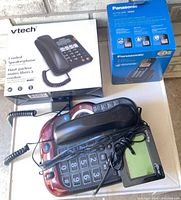 VTech corded phone box, Panasonic cordless phone box, Clarity burgundy phone, cords