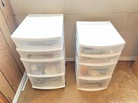 Two white plastic drawer units side by side