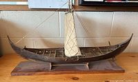 full view of wooden Viking longship model on stand