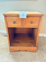 Front view showing drawer, knobs, open shelf, base cut-out