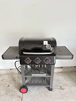 Front view of Coleman 3-burner propane BBQ on cart