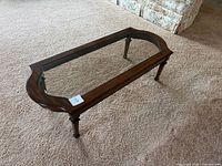 Full view of coffee table showing glass inset and wood frame