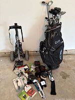 Overall lot with bag, pull cart, clubs, accessories