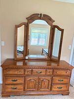 Front view of dresser with attached tri-fold mirror