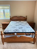 Full view of assembled queen bed with mattress and box spring