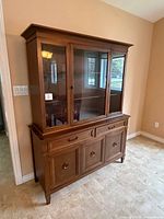 Full view of Krug wooden china cabinet showing upper glass display and lower storage section